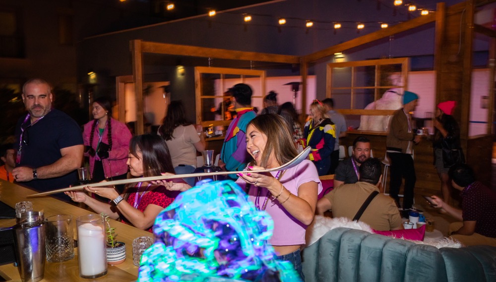 women enjoying a shotski at Pier Summit Ski Lodge at Kimpton Shorebreak Resort in Huntington Beach, CA