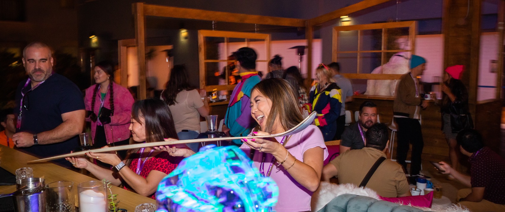 women enjoying a shotski at Pier Summit Ski Lodge at Kimpton Shorebreak Resort in Huntington Beach, CA